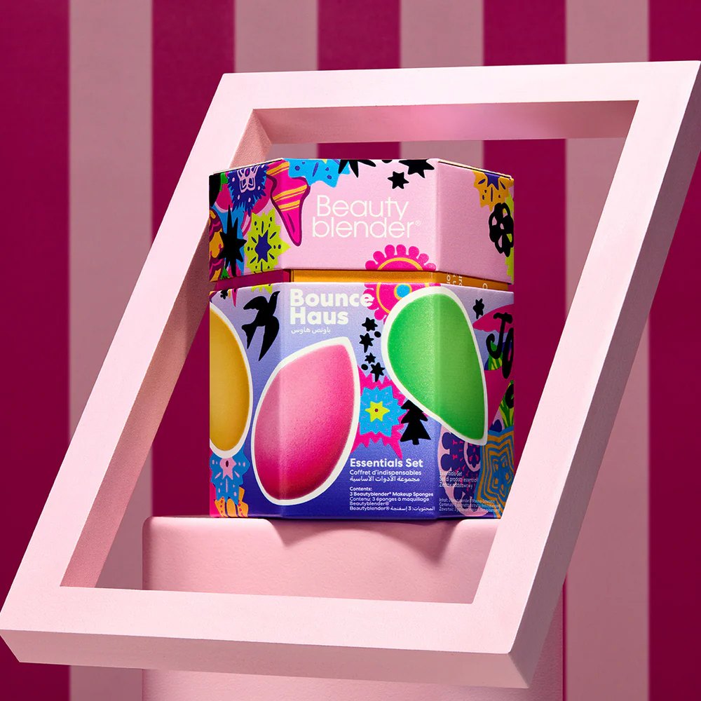 The hexagonal Bounce Haus box inside a pink frame, against magenta stripes