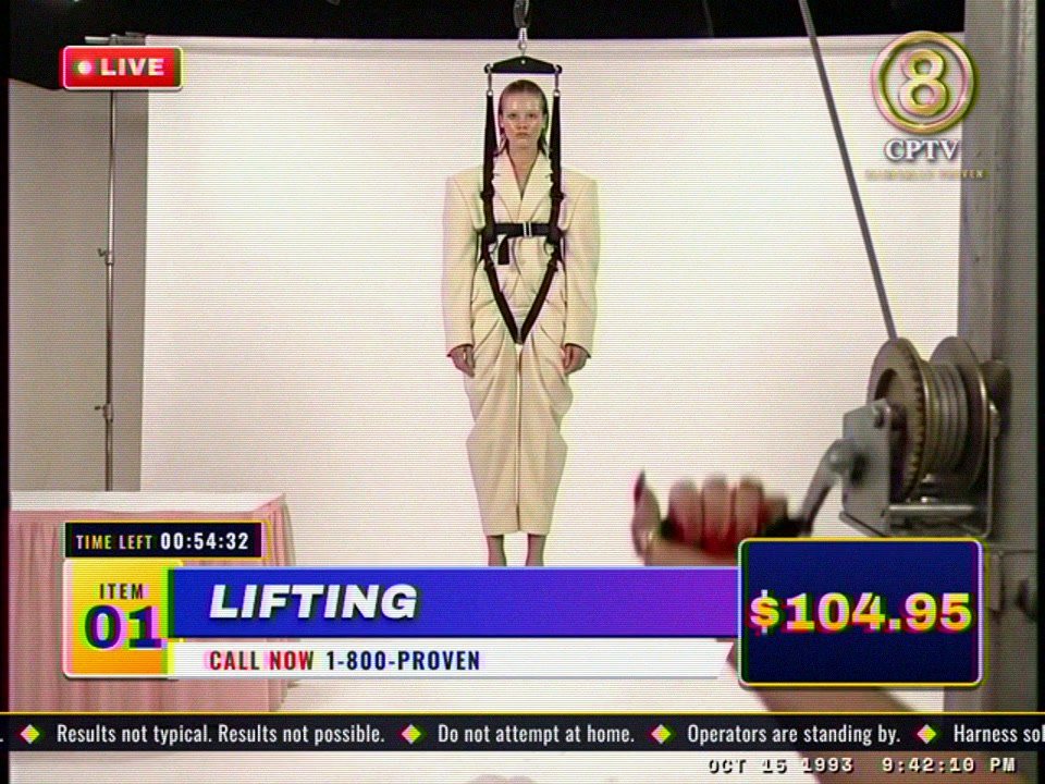 Ep. 01 as the 4:3 broadcast master: the model in a cream suit hangs in the harness on the white set, the winch at right, $104.95