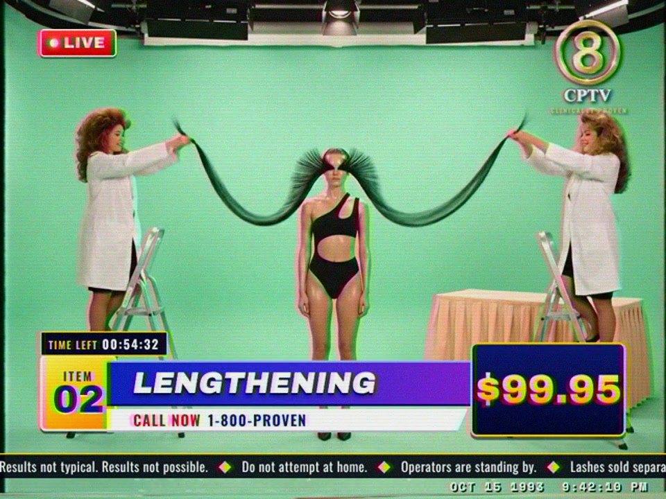 Ep. 02 in 4:3: two lab coats on stepladders stretch the lashes across the green studio, $99.95