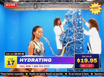 Style frame, item 17, Hydrating: a model drinking through tubes that run to a tower of water jugs