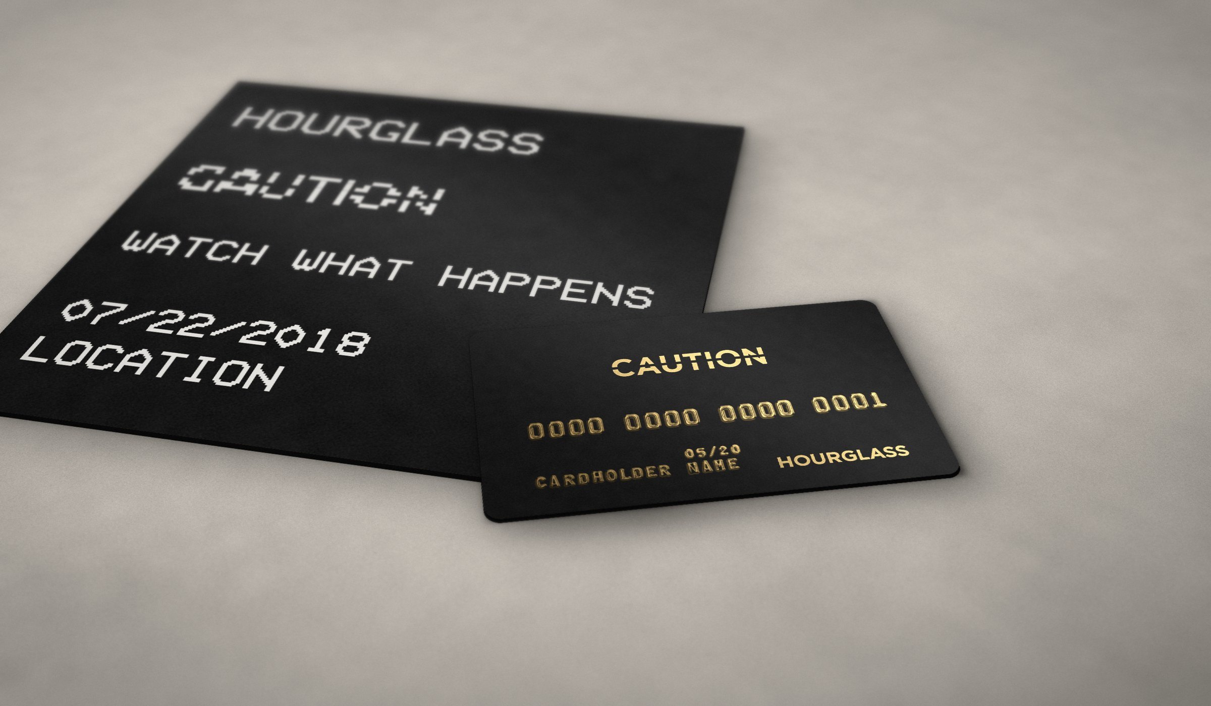 Mockup: the black CAUTION card with gold foil CAUTION and HOURGLASS and gold embossed numbers, resting on the black invitation printed HOURGLASS, CAUTION, WATCH WHAT HAPPENS, 07/22/2018, LOCATION in pixel type