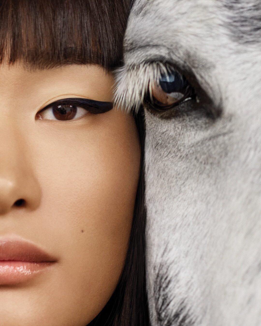 Portrait: a woman with a fringe and black eyeliner against a white horse’s eye