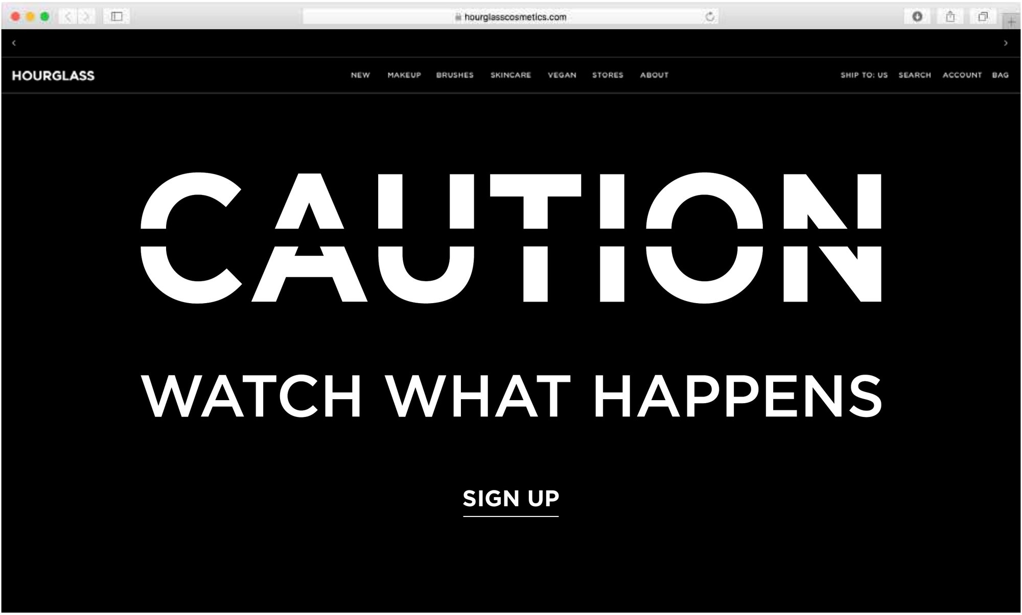 The Hourglass homepage in a browser window: CAUTION and WATCH WHAT HAPPENS in white on black above a SIGN UP link