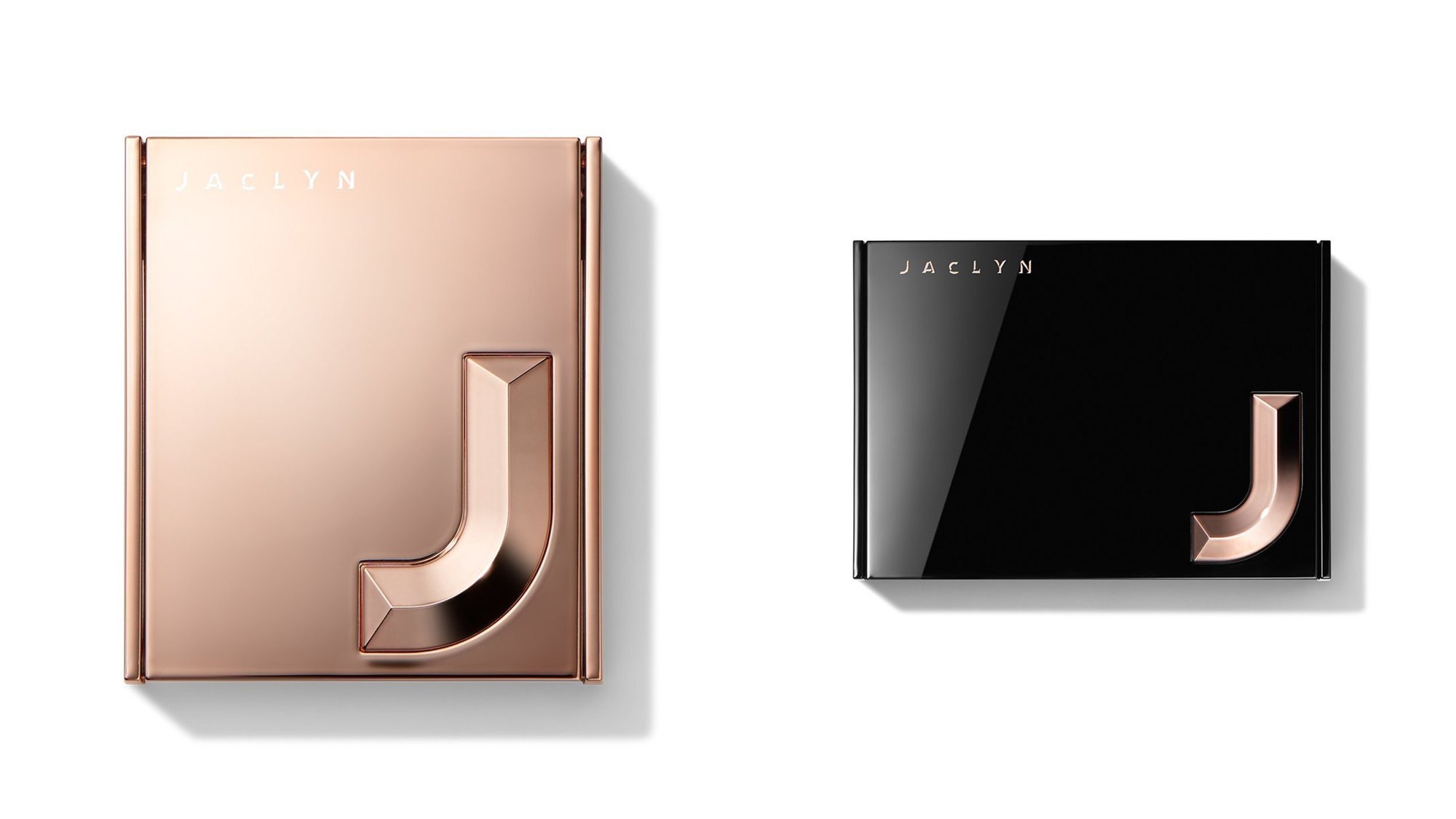 Rose gold and black compacts, each with the dimensional J