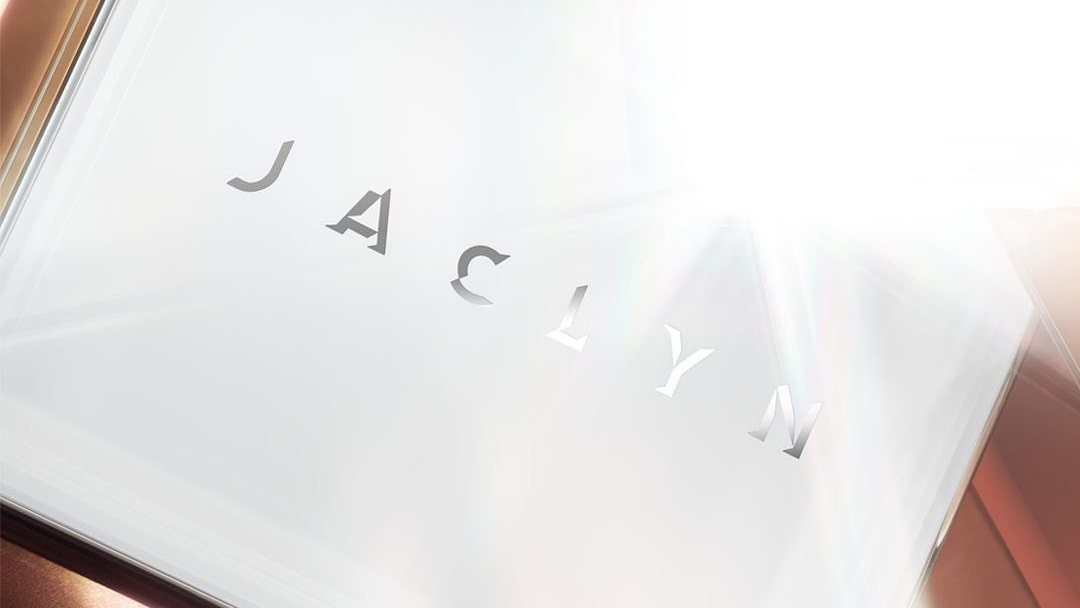 JACLYN wordmark embossed on a silver compact