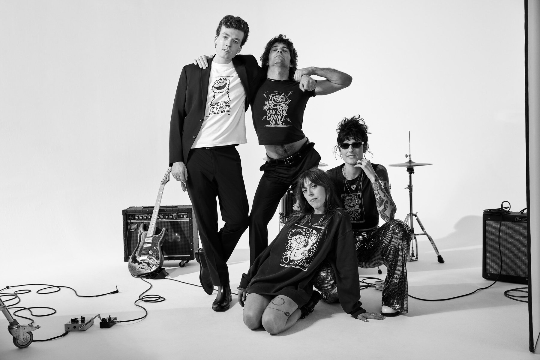 The band together in the studio in Sesame Street x Kenneth Cole tees
