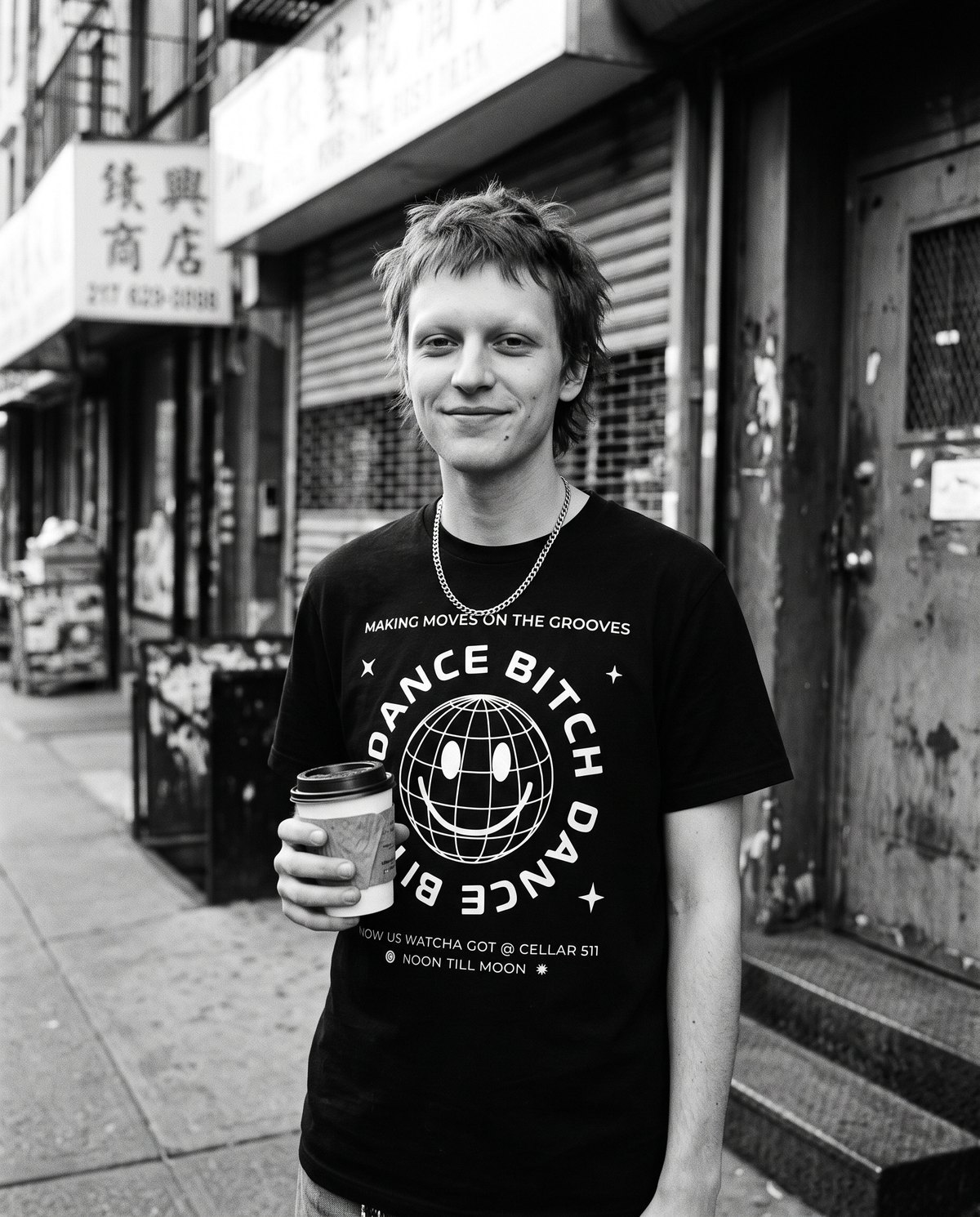 A young man with a coffee in the disco ball flyer tee