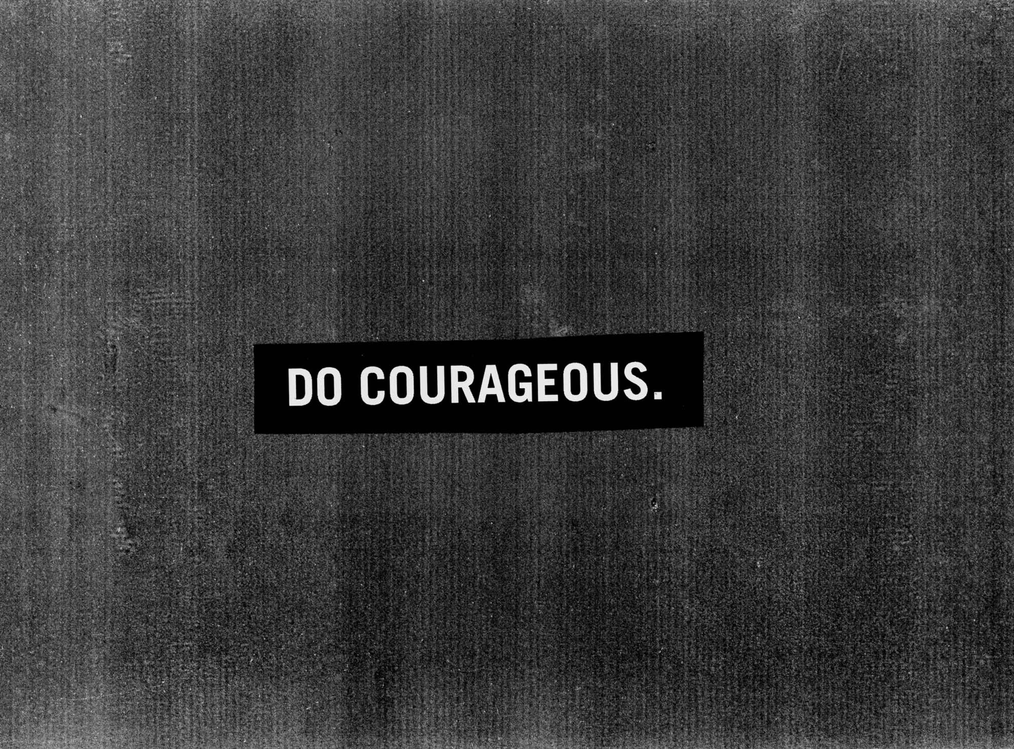A Do Courageous label on a full sheet of copier grain