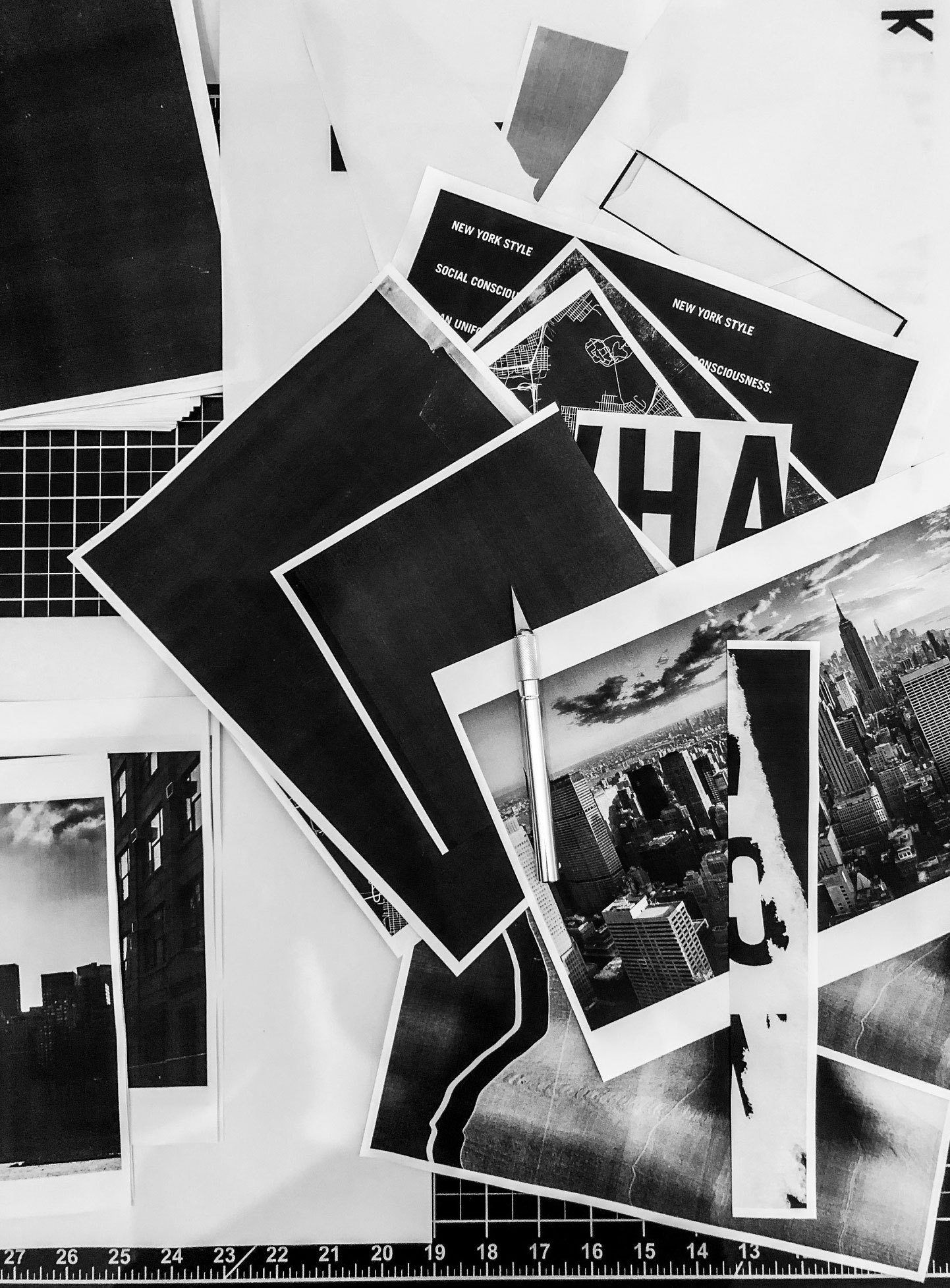 Copies and cut prints spread over a cutting mat with a craft knife