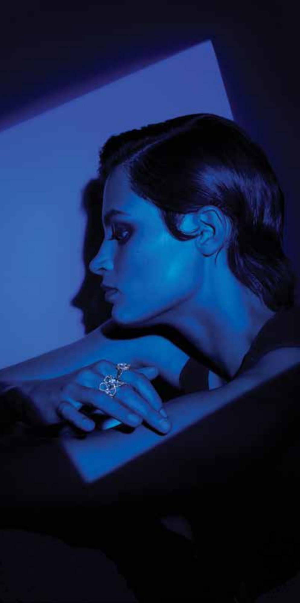 Influencer card front: a blue lit portrait with a ring