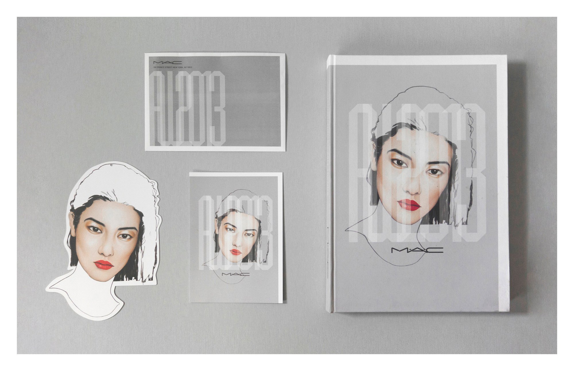 The AW13 book, cards and a cut-out face, with AW2013 lettered over a painted portrait