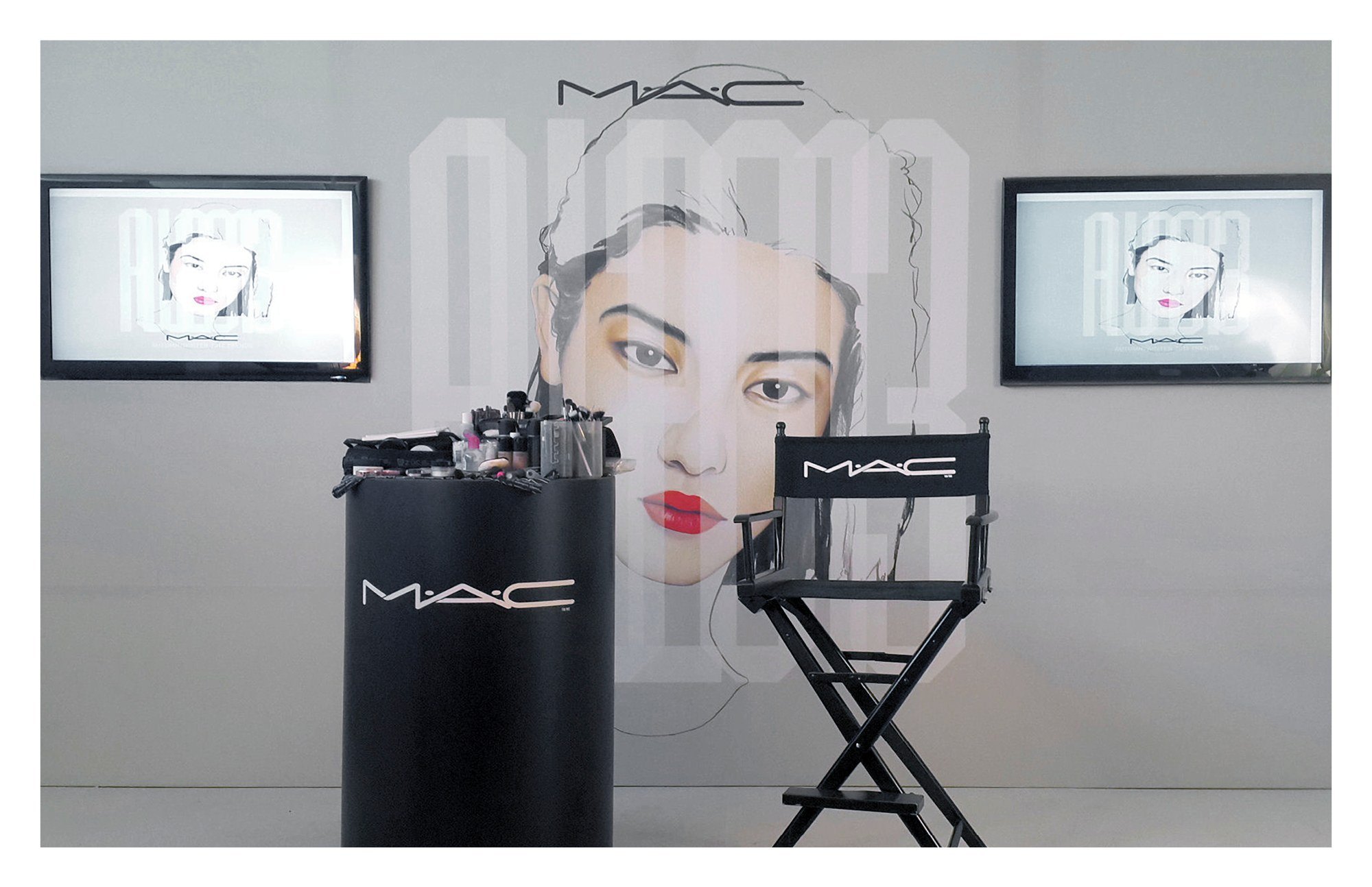 A M·A·C makeup station in front of the AW2013 face wall and two screens