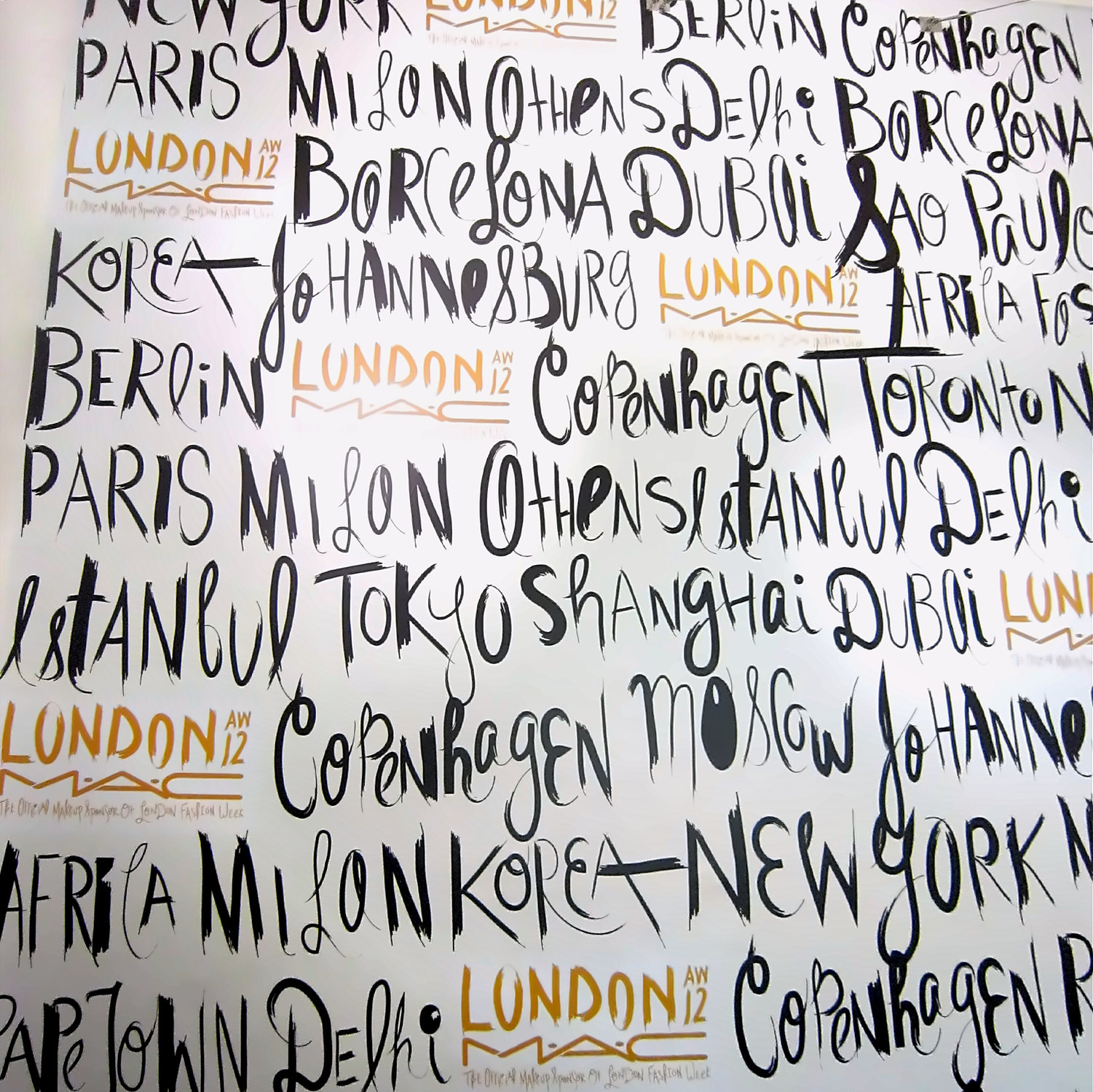 Close up of the hand-lettered wall: Paris, Milan, Athens, Istanbul, Tokyo, Shanghai, Copenhagen