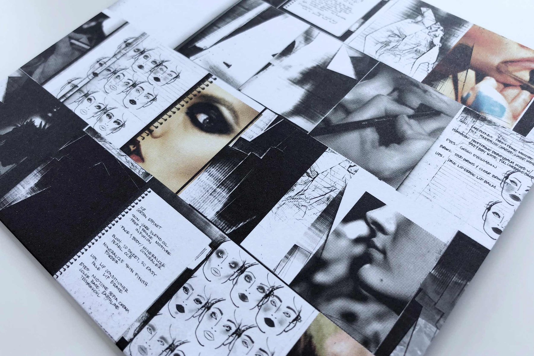 Close up of the card: face charts, eyes and handwriting in black and white