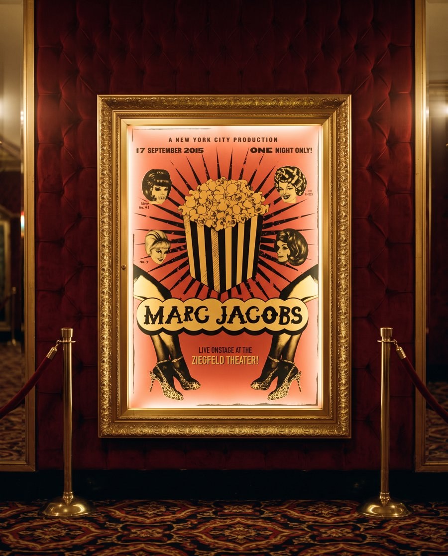 The Marc Jacobs show poster in a gilded frame on red velvet, between brass stanchions