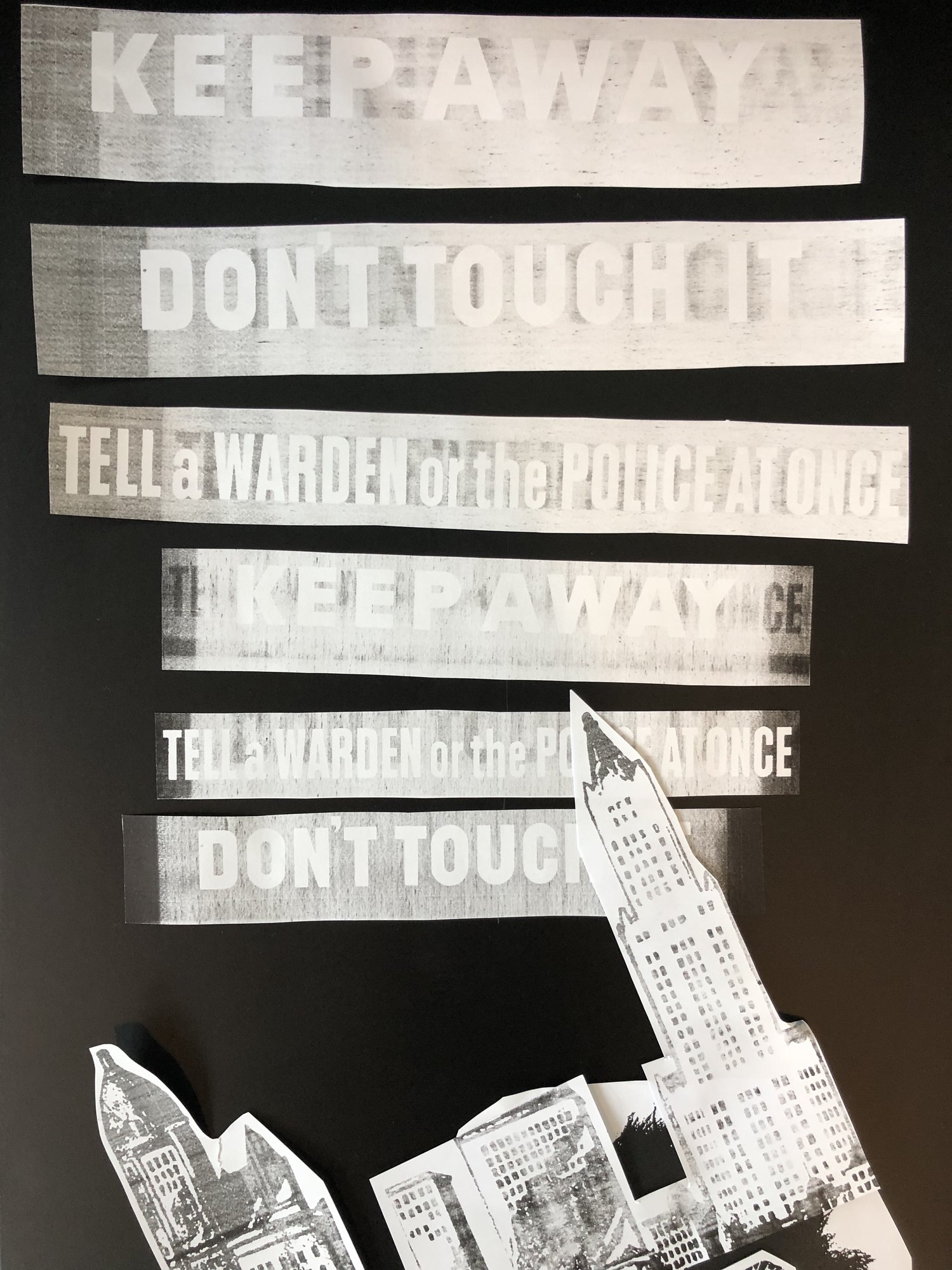 Strips of copied type, Keep away and Don’t touch it, cut out and laid on black beside a cut out skyscraper