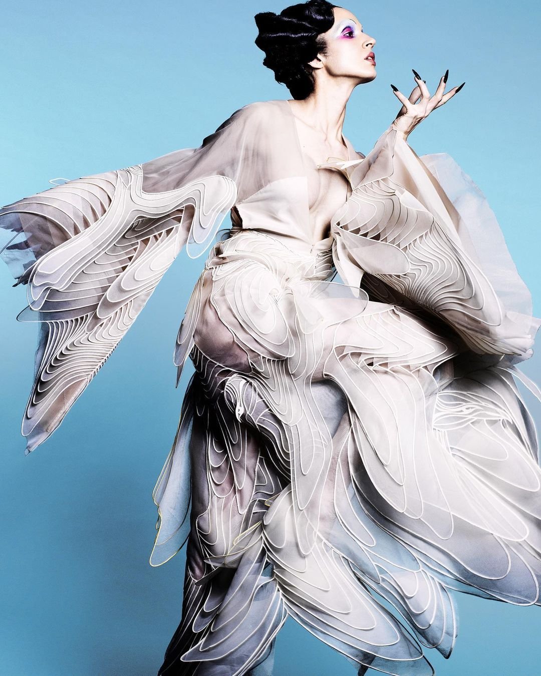Campaign portrait in a white feathered gown