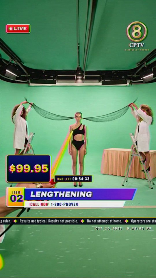 The wide shot: two assistants stretch the lashes across a green studio, the price at $99.95