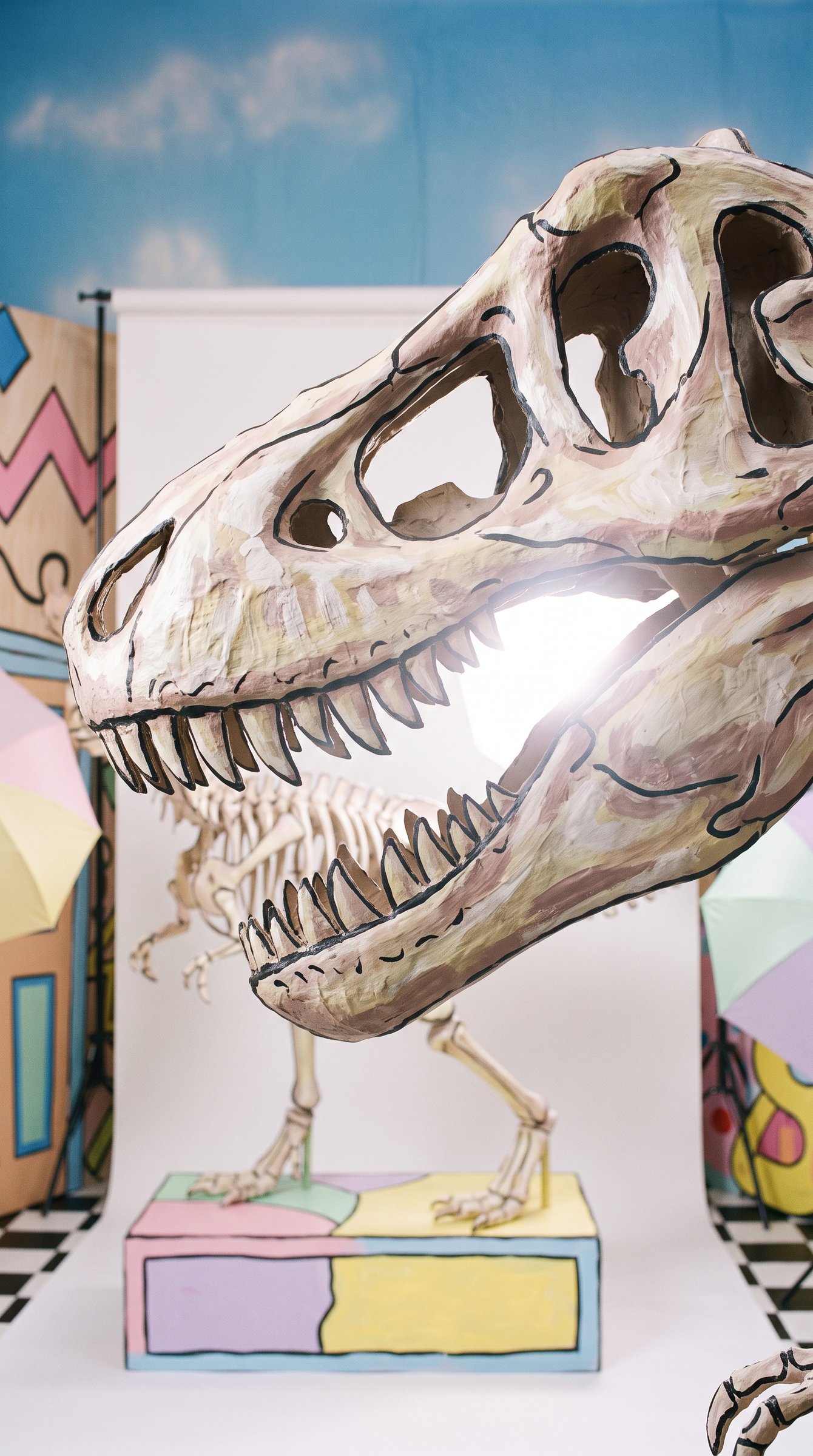 Episode 01, shot 1: close on the papier-mache T. rex skull as a flash pops