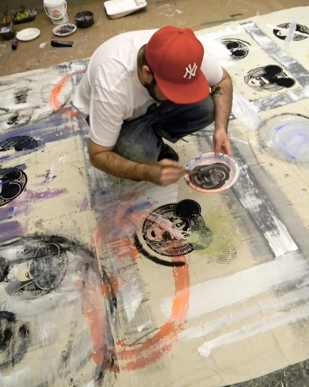 Painting a canvas on the floor, from above