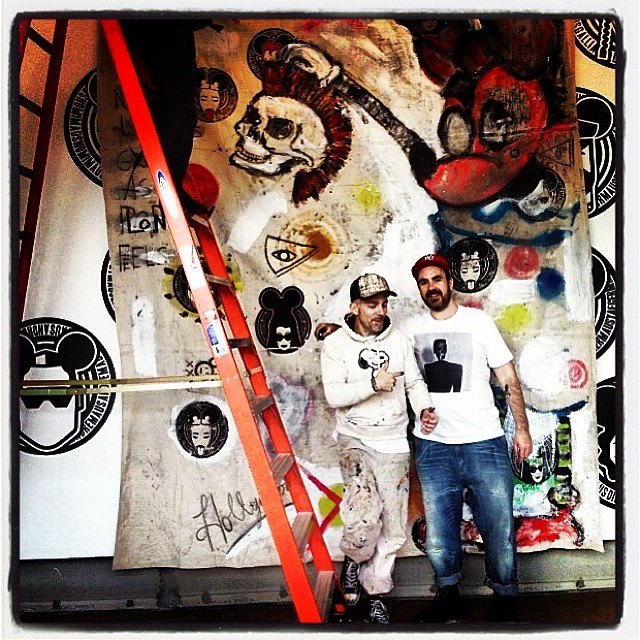 Scooter LaForge and Christopher Lee Sauvé in front of a painted MadMaus wall