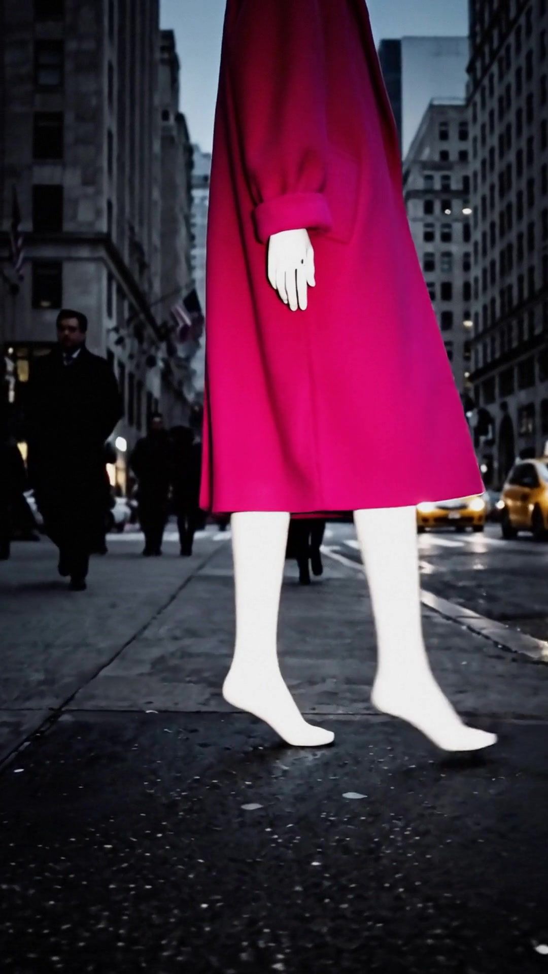Fifth’s legs and pink coat mid stride on a Fifth Avenue sidewalk