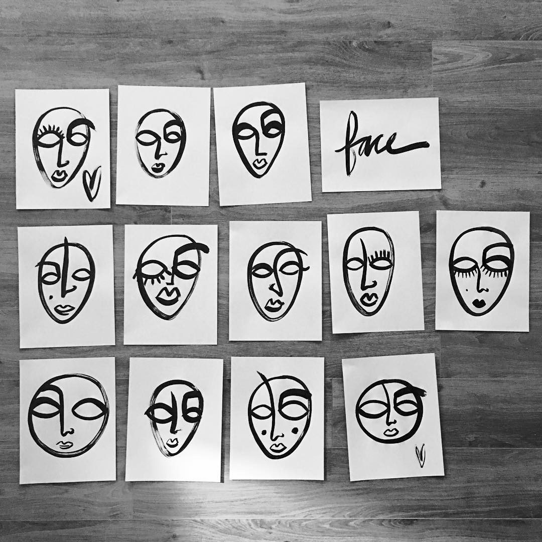 A wall of one-line ink face studies