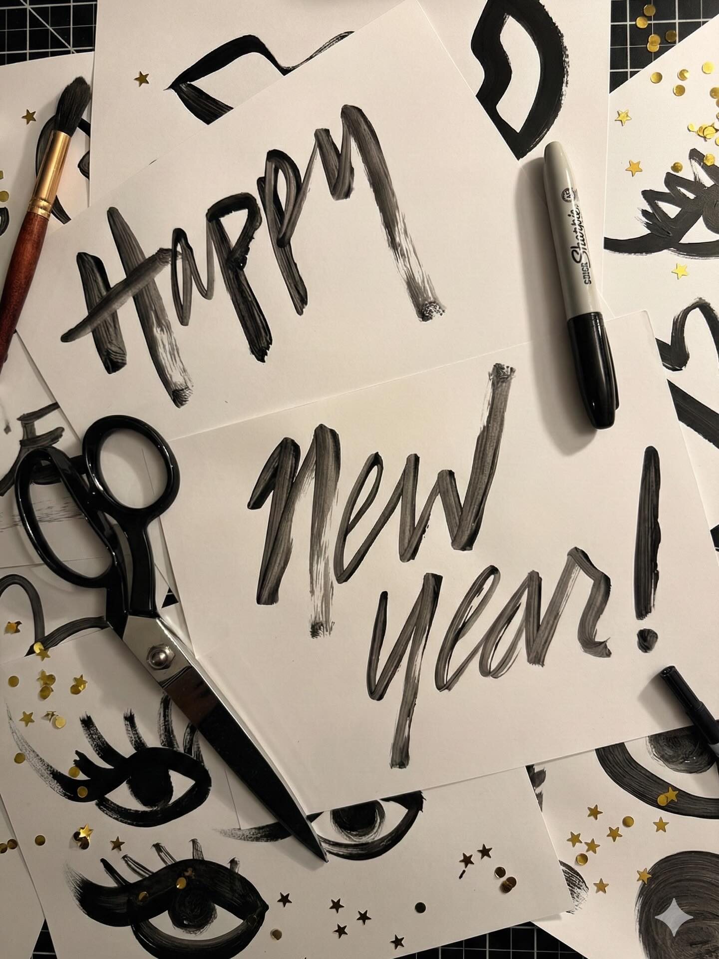 Happy New Year in brush lettering with scissors and markers