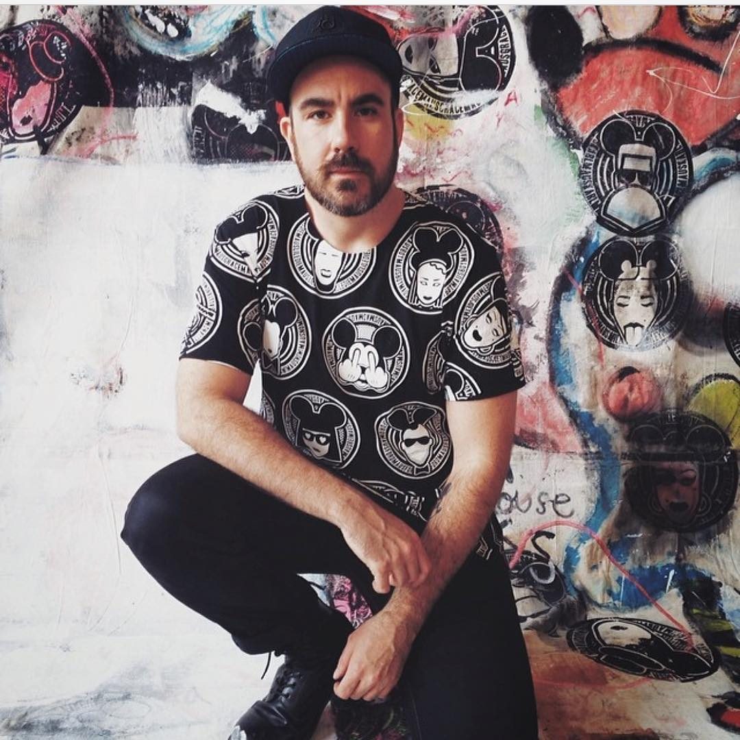 In a MadMaus print in front of painted records