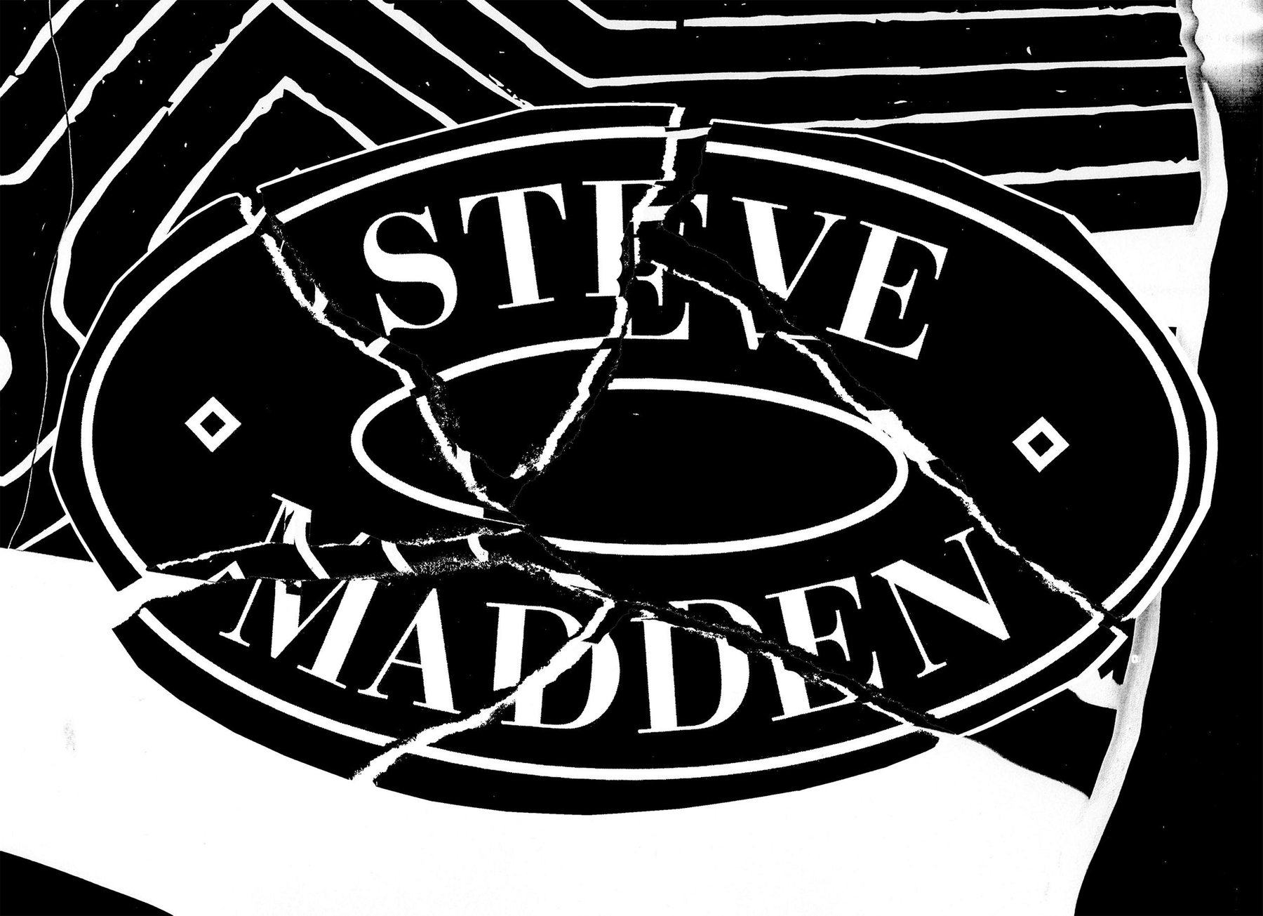 The Steve Madden oval logo, cut up and taped back together