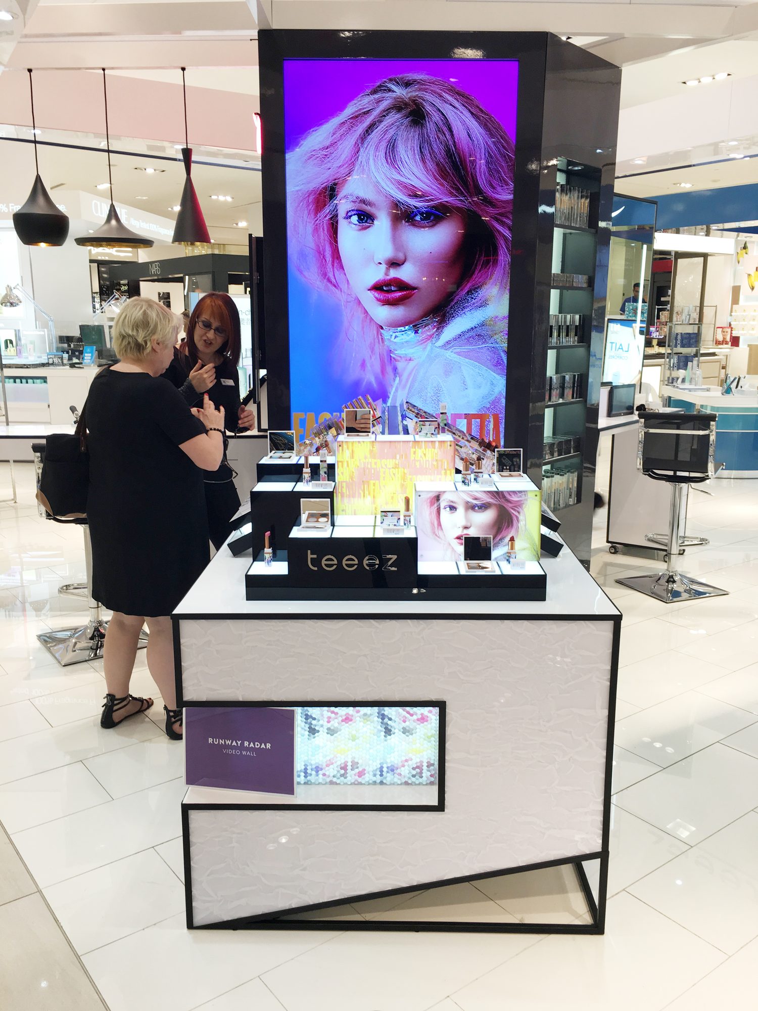 A Teeez kiosk with the campaign portrait on its vertical screen