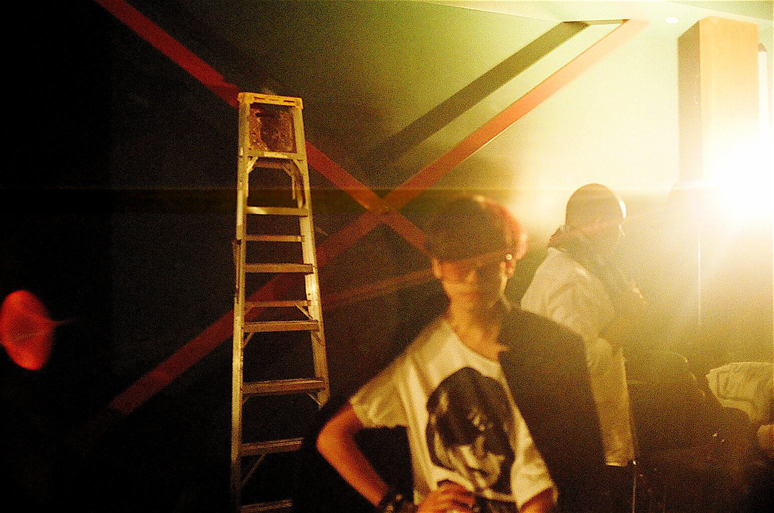Backstage in warm light, a Save Anna tee in the foreground