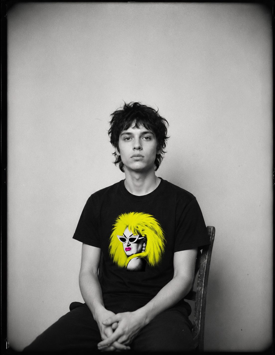Seated portrait in the Divine tee