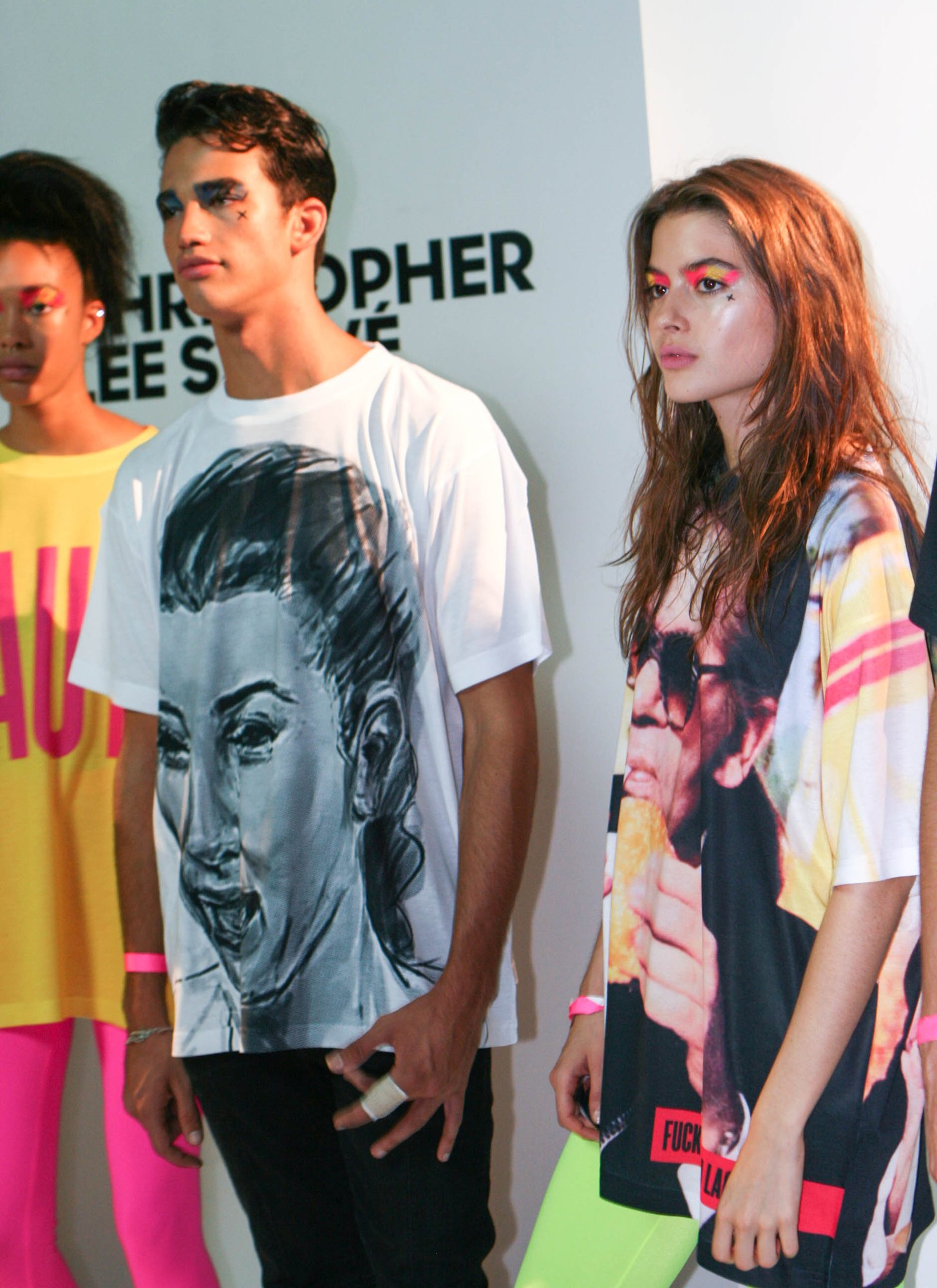 Presentation models in a hand drawn portrait tee and a print tee with neon tights