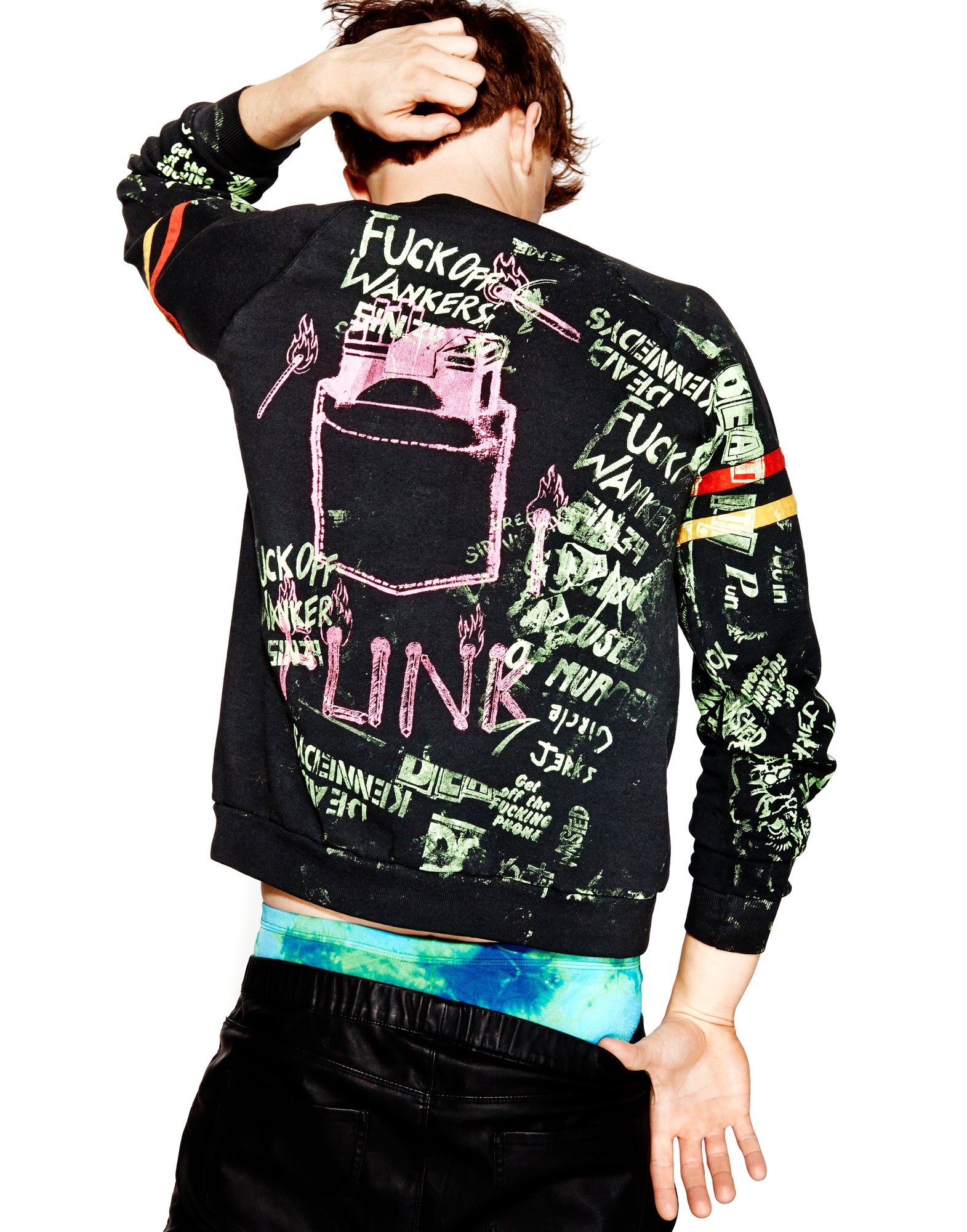Model from behind in a black printed sweatshirt covered in scrawled lettering