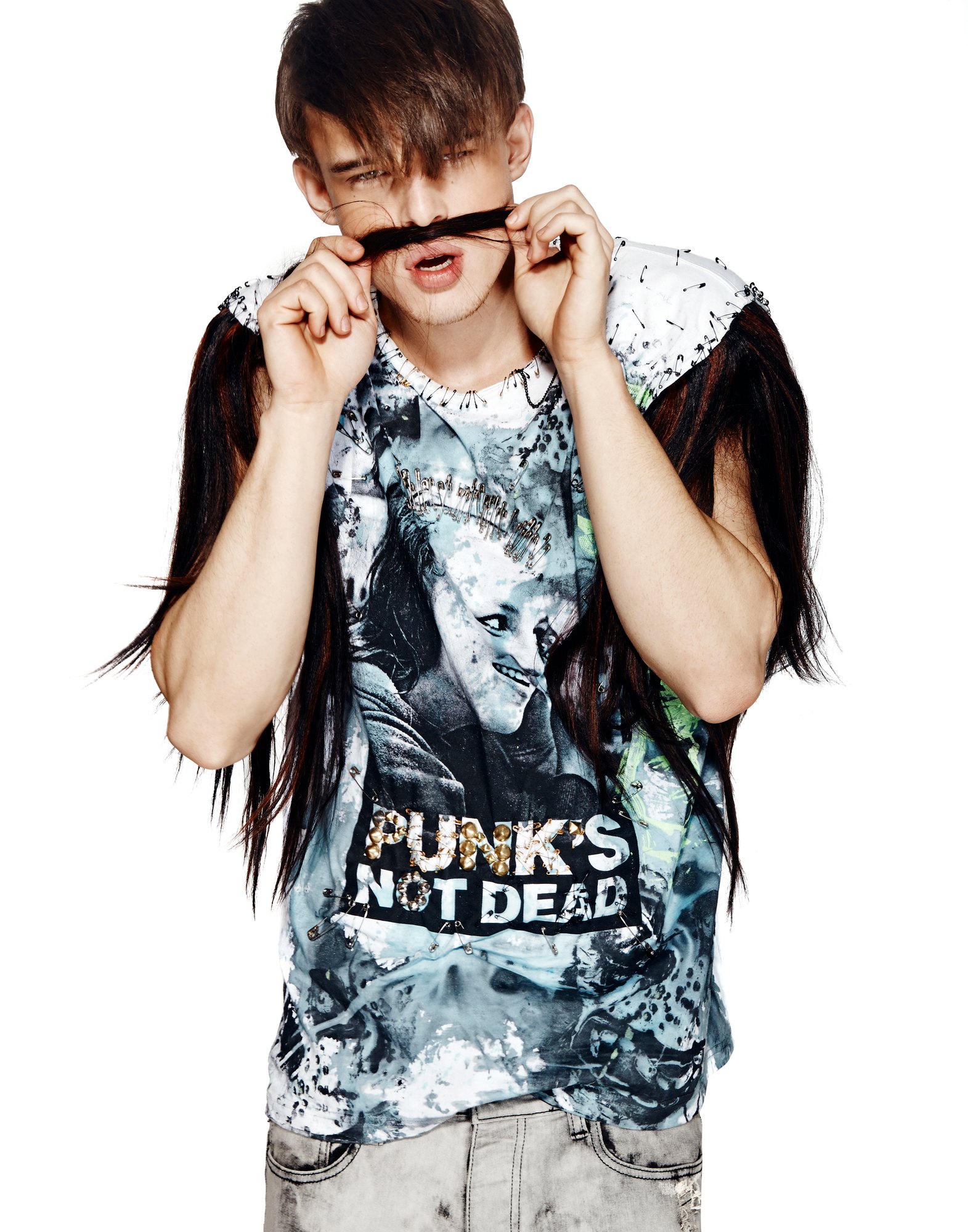 Model with a hank of hair as a moustache in a hand painted Punks Not Dead tee