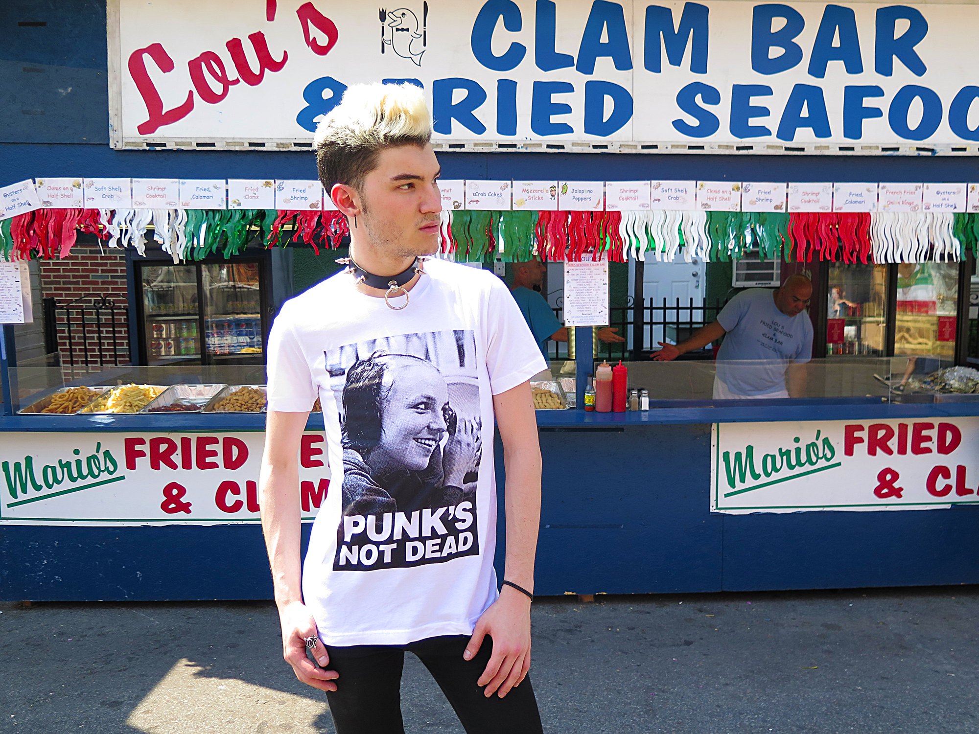Model in the Punks Not Dead tee outside a clam bar