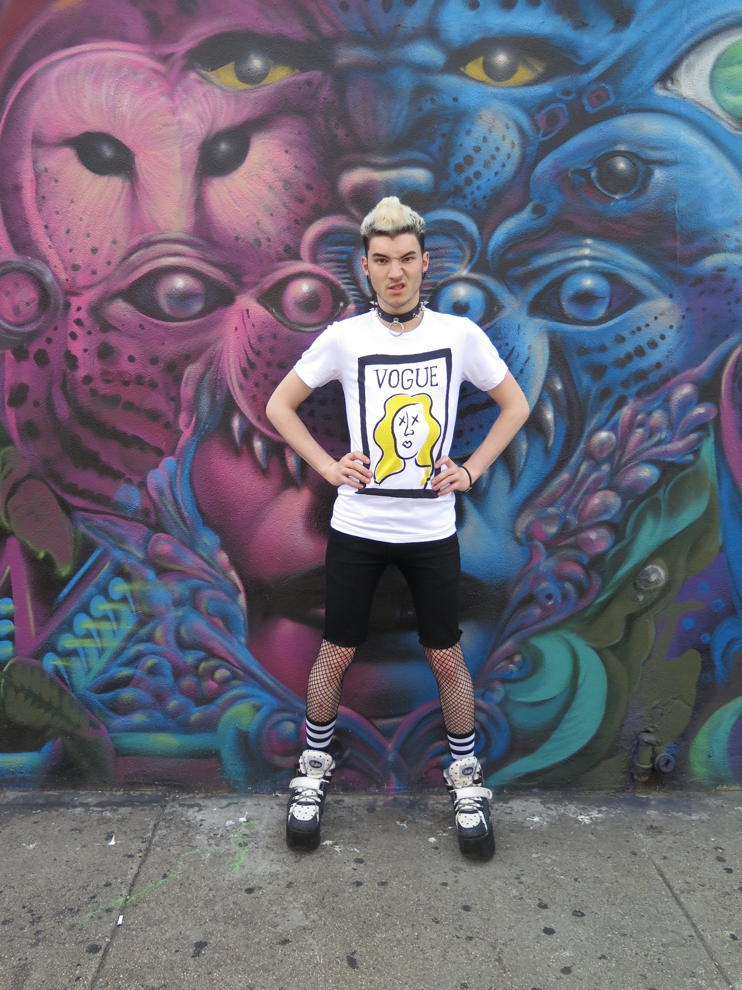 Model in the VOGUE cover tee in front of a painted mural