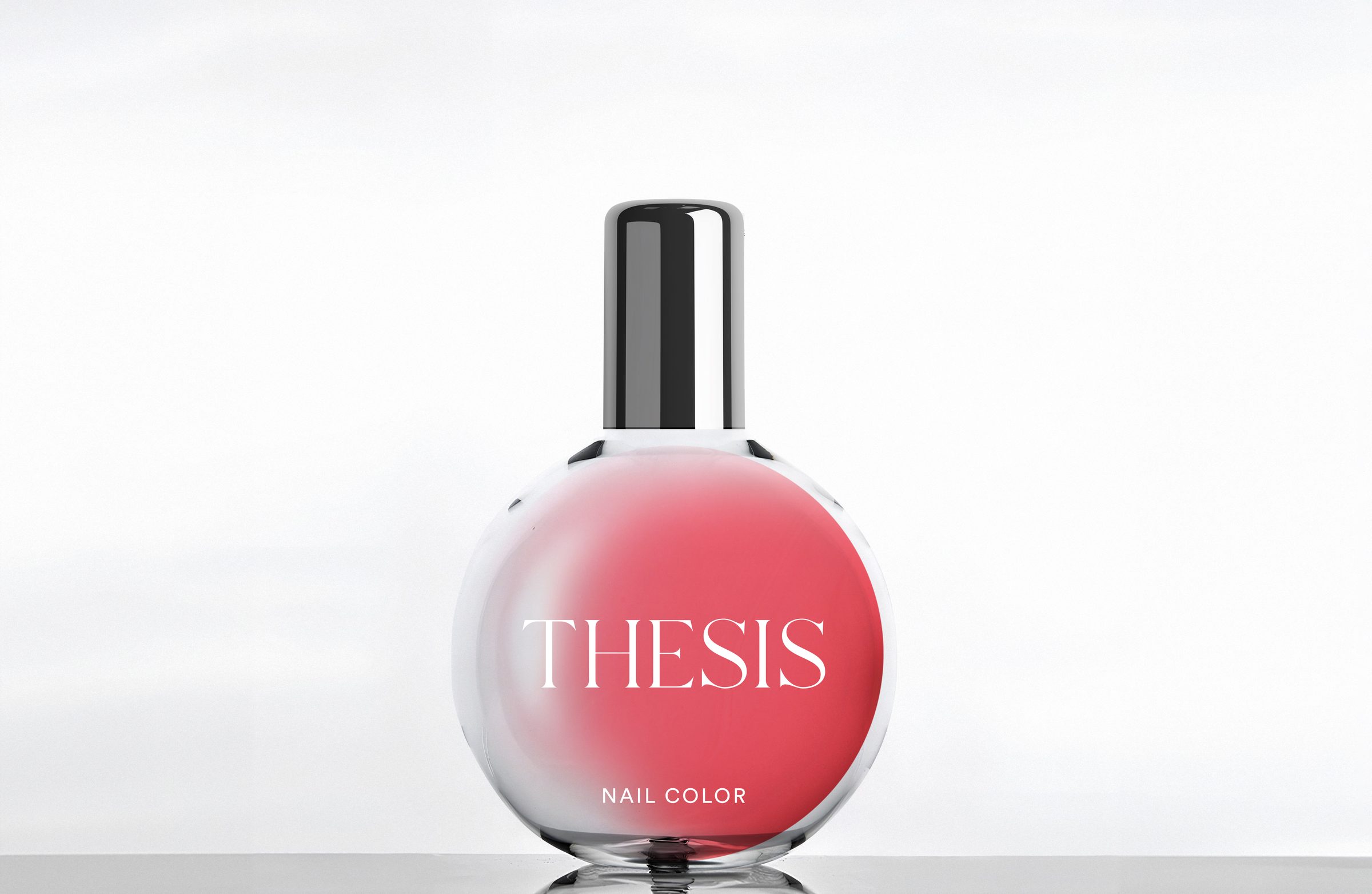 A round glass nail polish bottle with a silver cap and a coral THESIS label