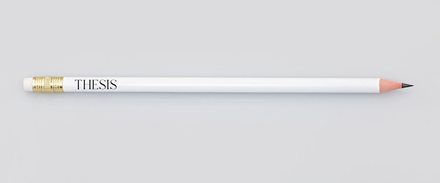 A white pencil printed with THESIS