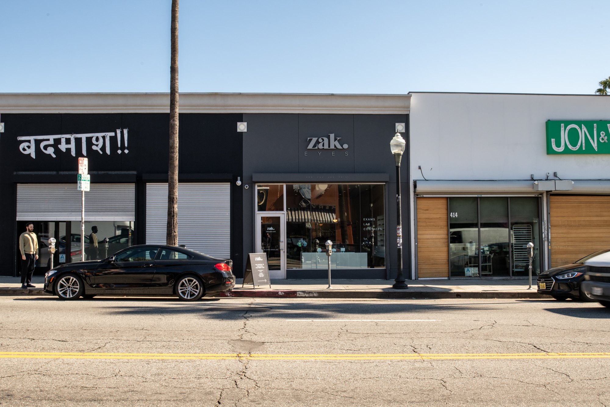 The black Zak. storefront on Fairfax Avenue with a palm tree and parked cars